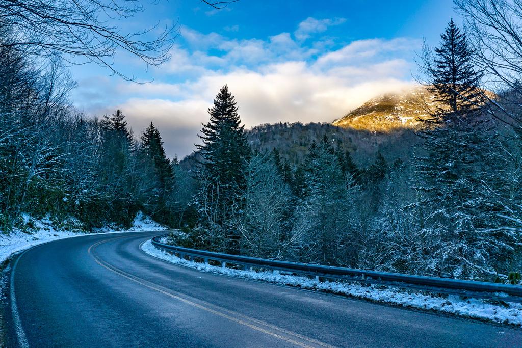 Sunlight on Sam Knob above the snowy West Fork Pigeon River Valley