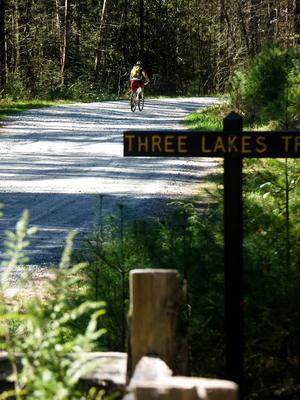 Rider on Conservation Road at the Three Lakes trail